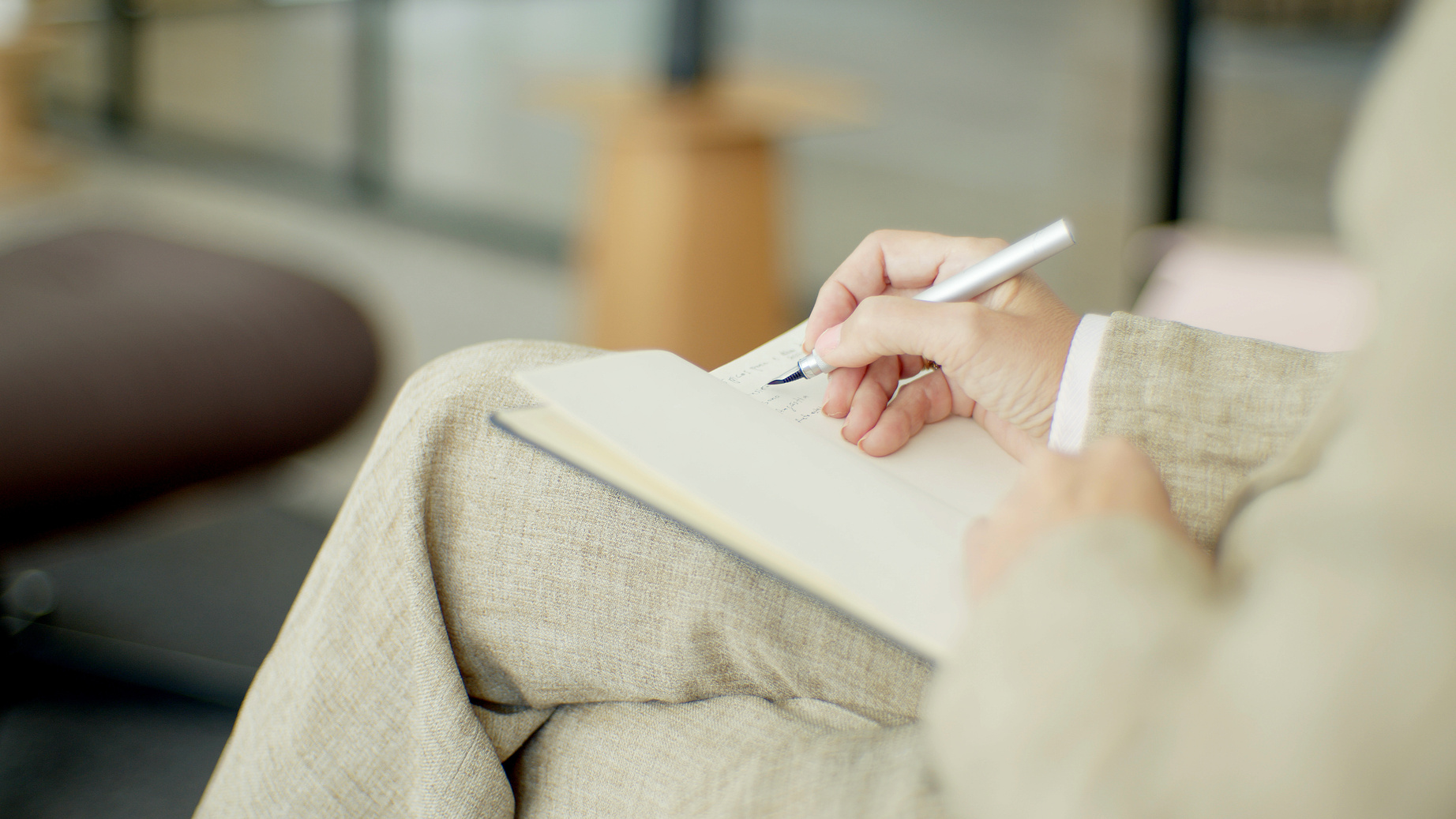 A Person Writing on Notebook